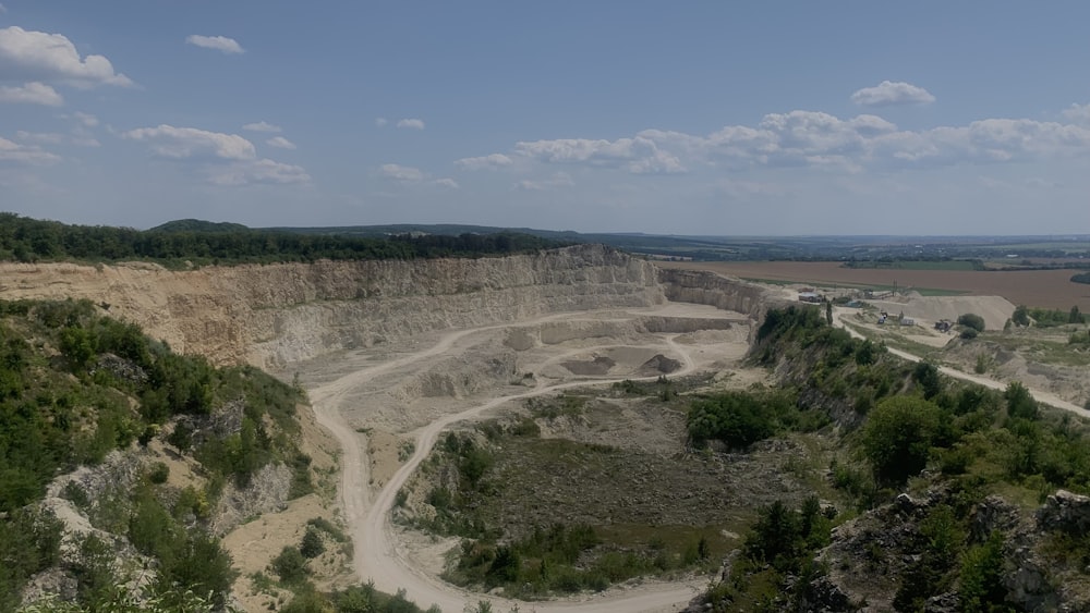 Vue aérienne d’un chemin de terre traversant une vaste fosse d’extraction